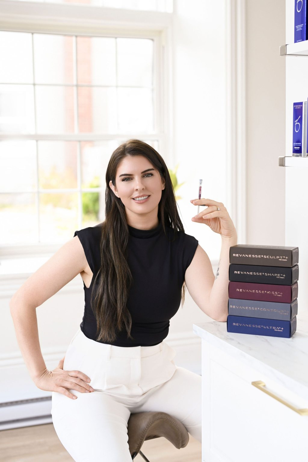 stacey foster holding a syringe of dermal filler
