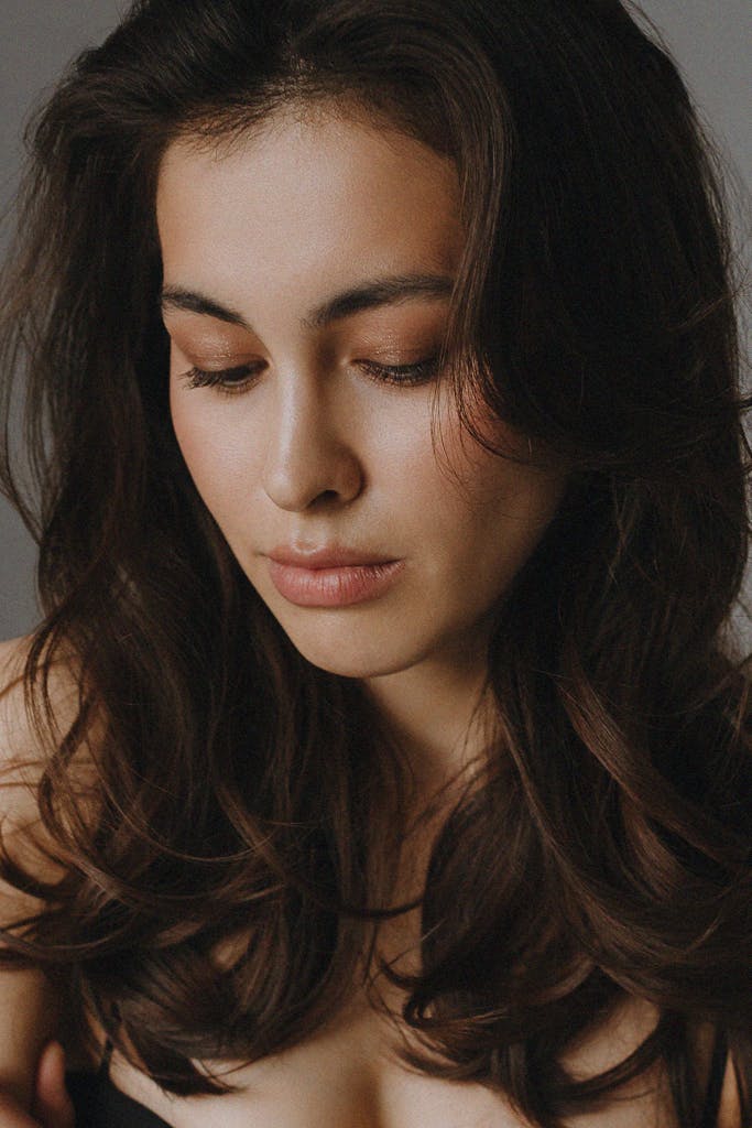 Close-up portrait of a woman with natural beauty, serene and thoughtful expression.